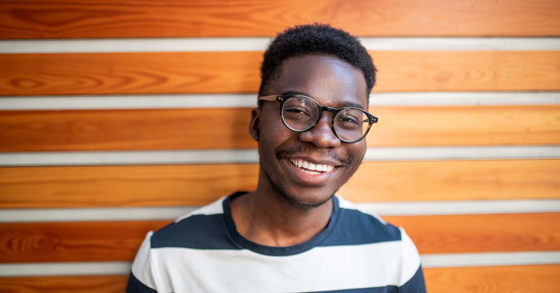 Young male with glasses and striped shirt