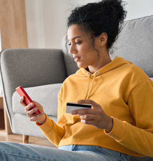 a woman walking through the city on her phone