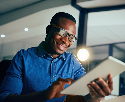 Man easily making a payment on his tablet at home