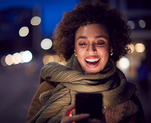 Woman easily making a payment on her phone while on the go