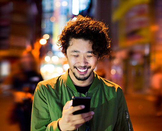 a young man using a phone at night
